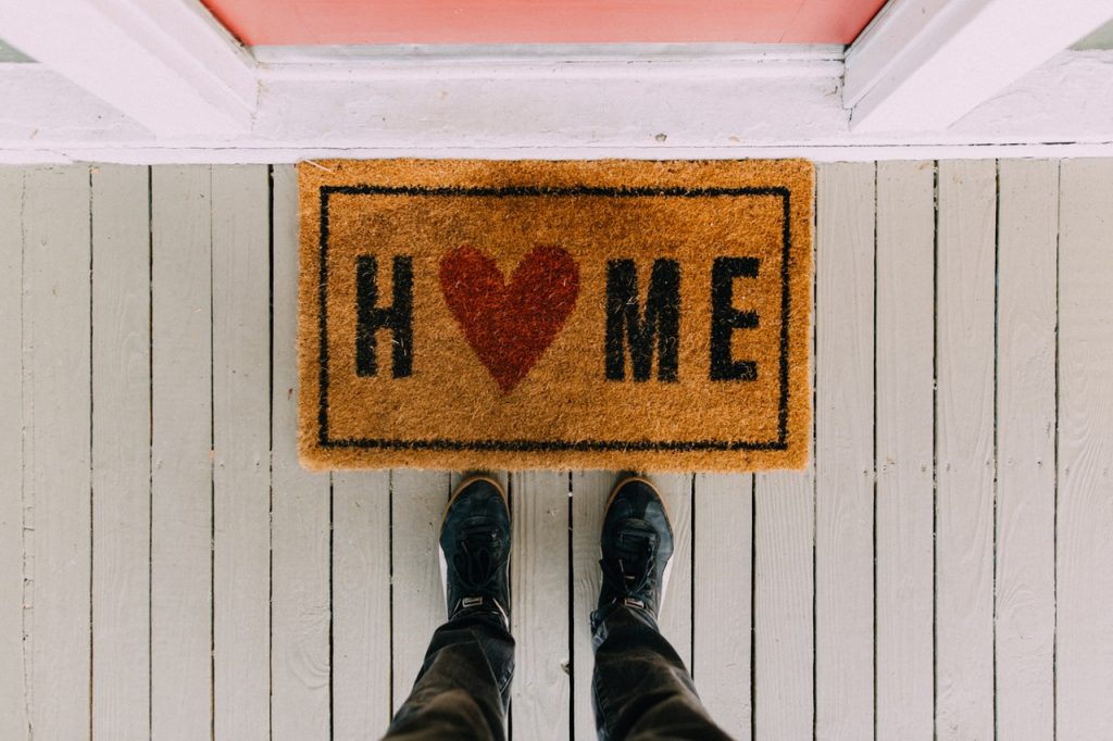 a person's feet in front of a sign