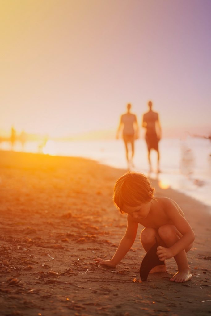 a group of people walking on a beach