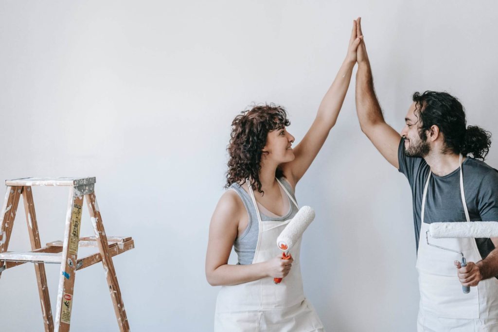 a man and woman raising their hands