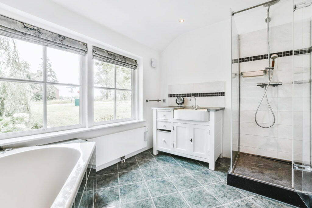 a bathroom with a tub sink and a window